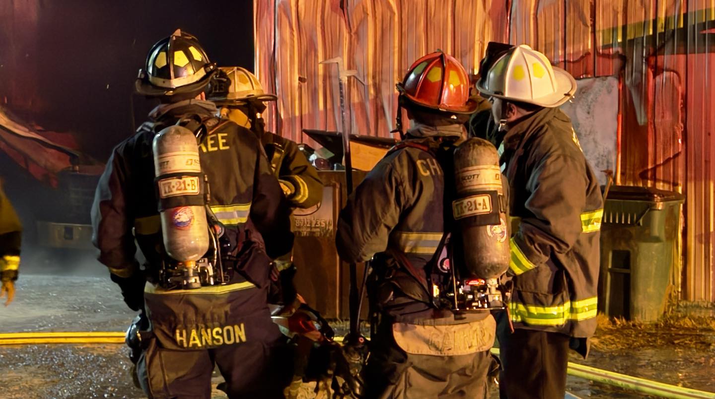 Firefighters receive orders from a Division Chief on scene. 
