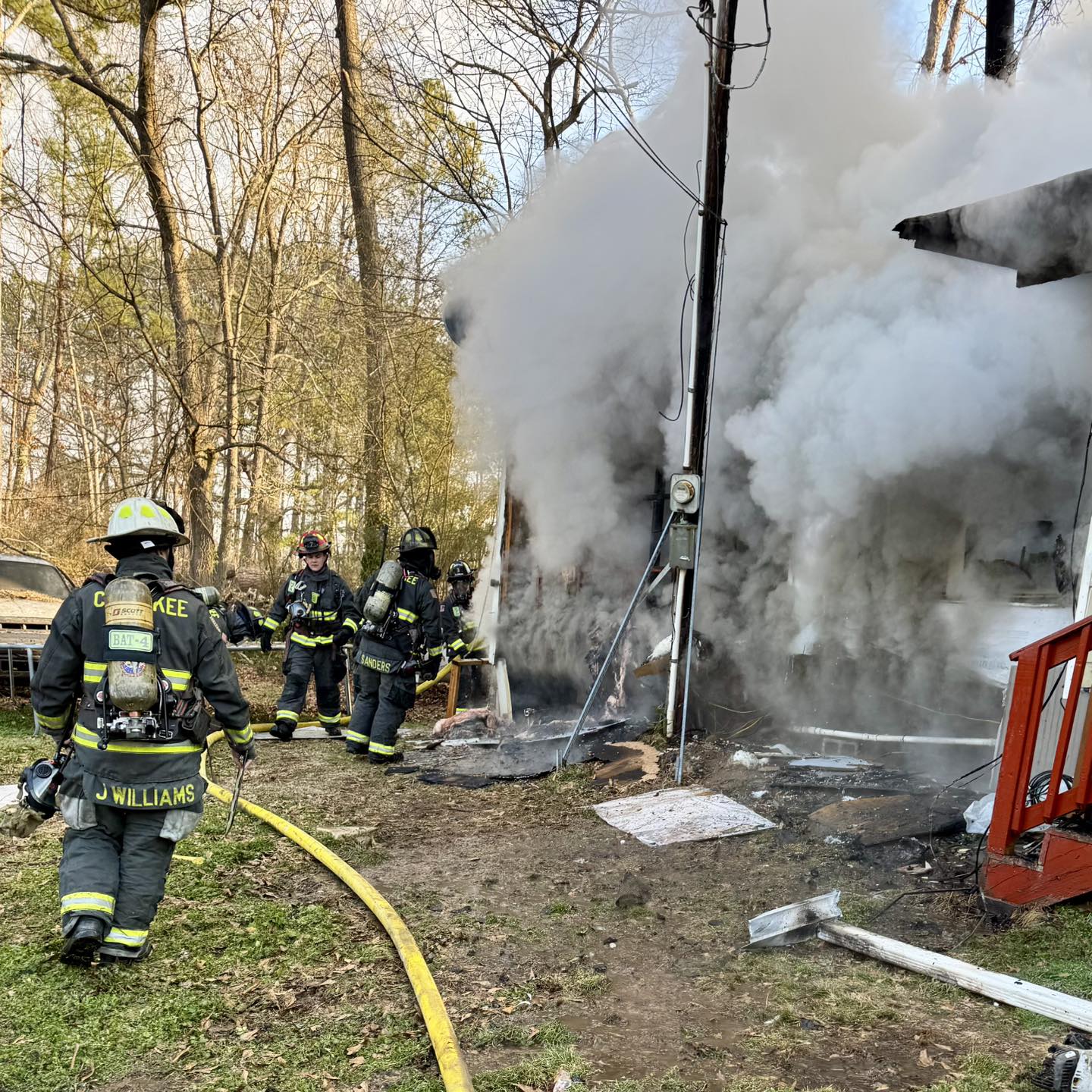 Firefighters work at the scene of a structure fire