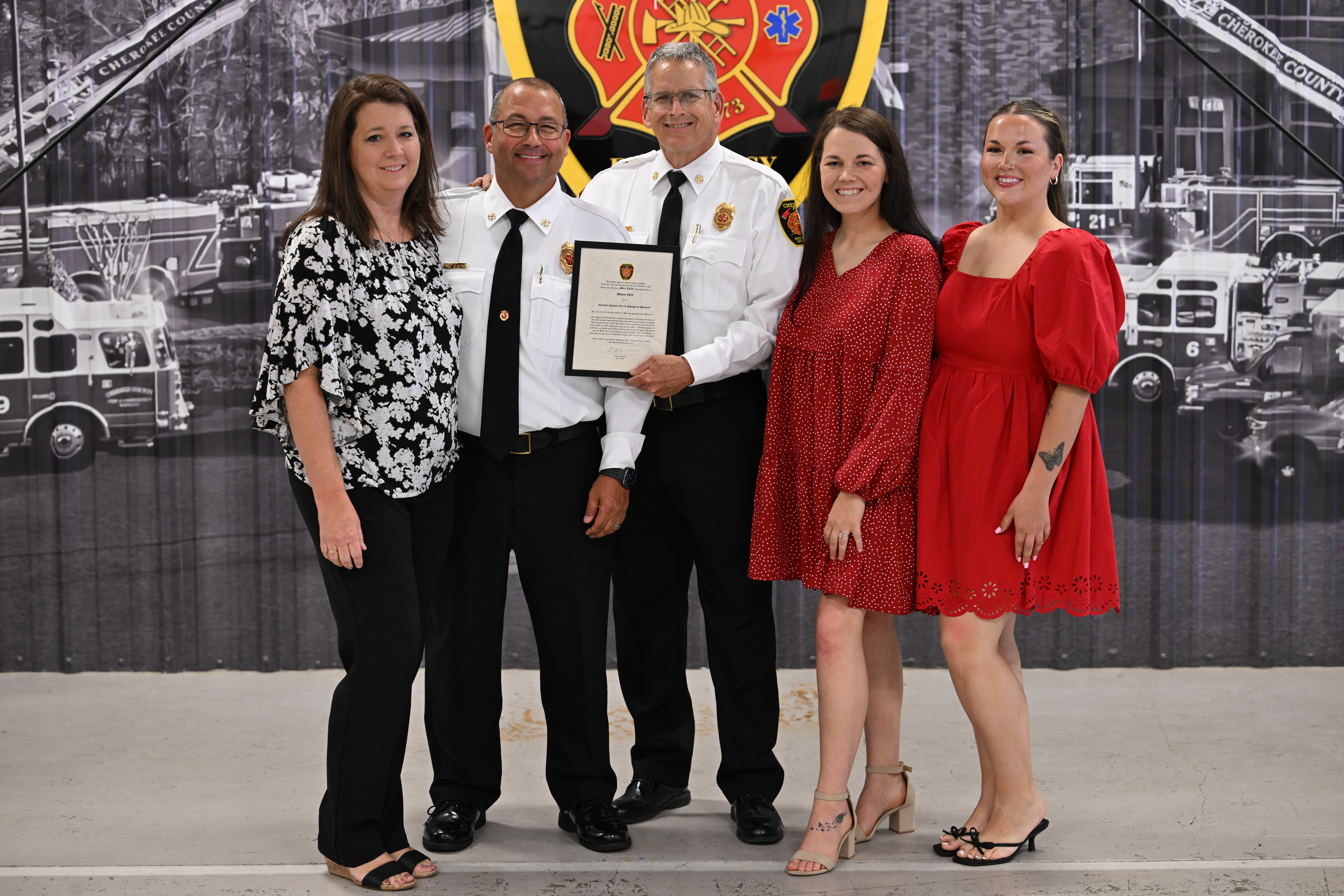 Chief Robinson congratulates Deputy Chief Marc Liscio and his family. 