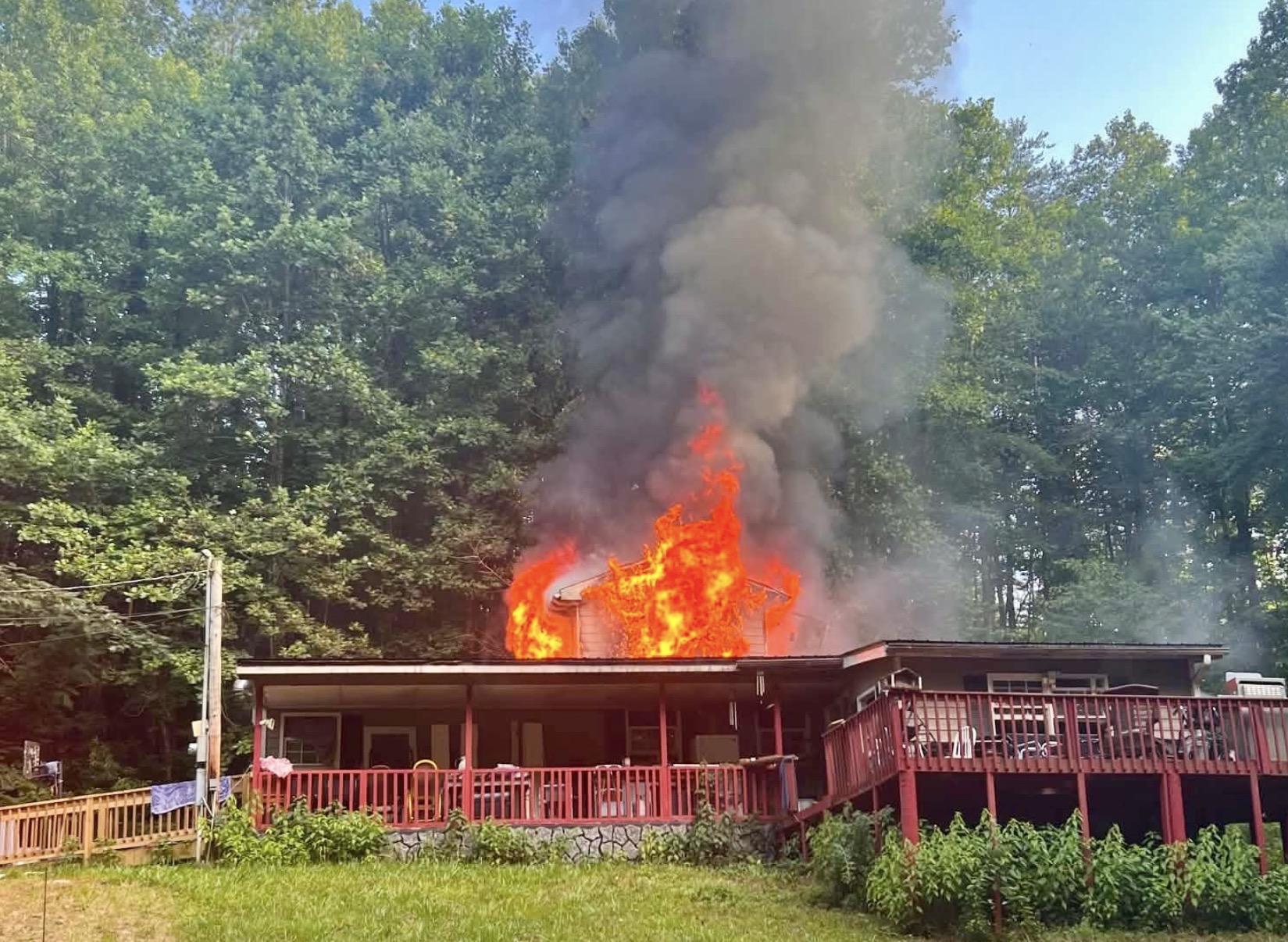 House on fire with smoke and flames. 