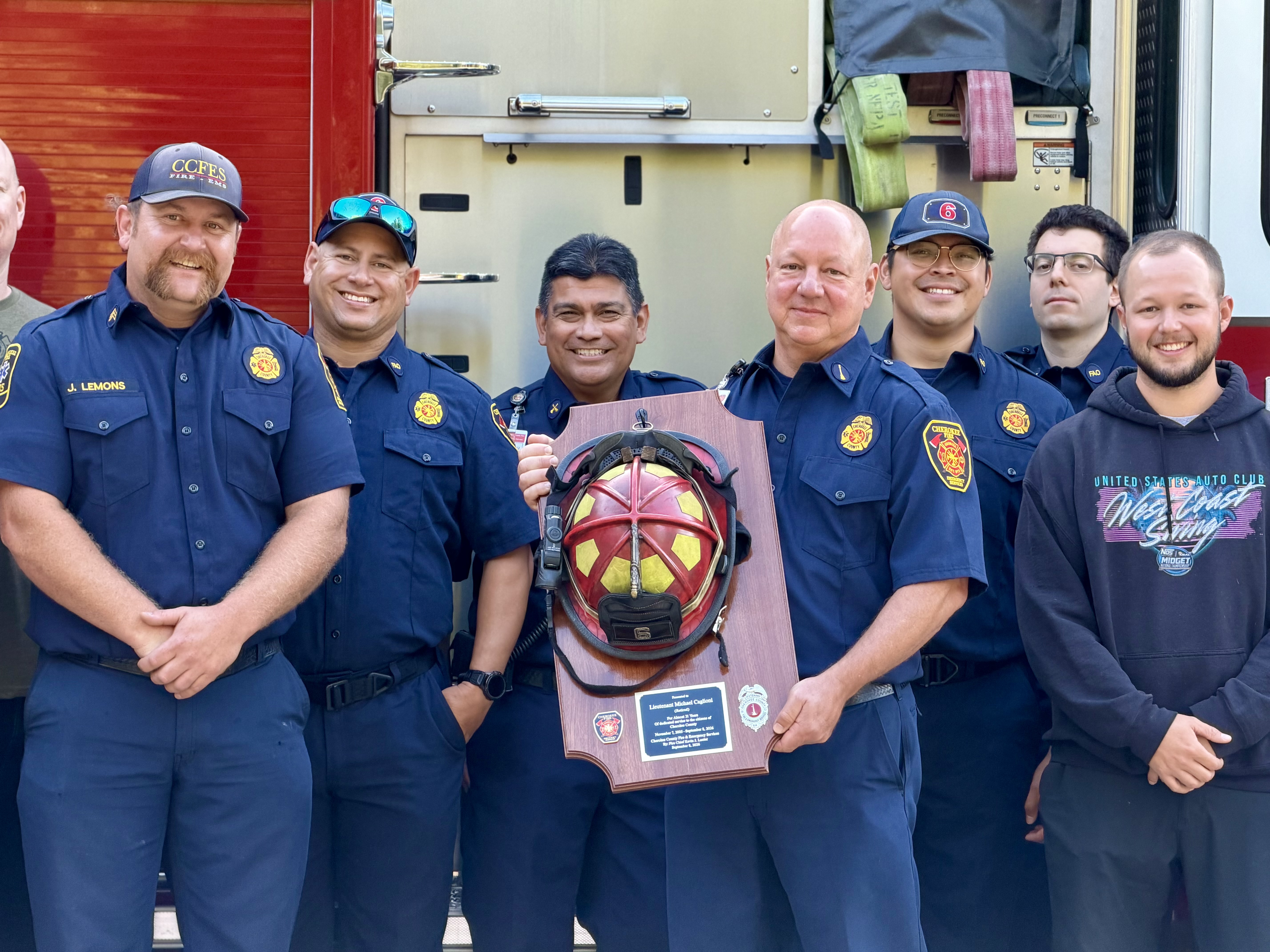 Lieutenant Caglioni with fellow firefighters at his retirement ceremony.  